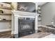 Living room features a fireplace, mantle, built in shelving, and dark hardwood floors at 1026 Slew O Gold Ln, Indian Trail, NC 28079