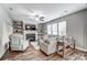 Living room boasts a fireplace, built-in shelving, fan, and hardwood flooring throughout at 1026 Slew O Gold Ln, Indian Trail, NC 28079