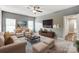 Staged living room with ceiling fan, neutral colors, and lots of natural light at 1026 Slew O Gold Ln, Indian Trail, NC 28079