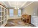 A bright living space with a piano, complemented by natural light and tasteful decor at 1026 Slew O Gold Ln, Indian Trail, NC 28079