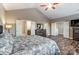Bright main bedroom with hardwood floors, ceiling fan, and multiple entrances at 1026 Slew O Gold Ln, Indian Trail, NC 28079