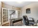 A cozy office space with French doors, and a desk with stairs visible through the doors at 1026 Slew O Gold Ln, Indian Trail, NC 28079