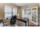 Home office with ample natural light, a large desk, and stylish French doors to the foyer at 1026 Slew O Gold Ln, Indian Trail, NC 28079