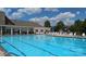 Community pool with clear blue water, lounge chairs, and a clubhouse, perfect for summer days at 1026 Slew O Gold Ln, Indian Trail, NC 28079
