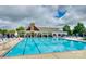Large community pool with surrounding lounge chairs, set against a clubhouse backdrop at 1026 Slew O Gold Ln, Indian Trail, NC 28079