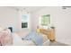 Bright bedroom with a large window, stylish dresser, and cozy bedding at 1027 Hostler Ln, York, SC 29745