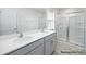 Modern bathroom featuring a double vanity with quartz countertops and a glass-enclosed shower at 1031 Hostler Ln, York, SC 29745