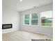 Bright and airy living room with large windows, modern flooring, and contemporary fireplace at 1031 Hostler Ln, York, SC 29745