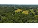 Expansive aerial view of a lush, wooded lot with interspersed, cultivated hay fields ready for development at 1040 Nc 90 W Hwy, Taylorsville, NC 20681