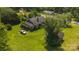 Aerial view of brick home on a sprawling lot featuring mature trees, lush green grass and ancillary structures at 1040 Nc 90 W Hwy, Taylorsville, NC 20681