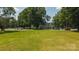 Sprawling front yard with a view of the white, two-story home behind mature trees and expansive lawn at 1040 Nc 90 W Hwy, Taylorsville, NC 20681