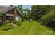 Charming brick home featuring a lush front yard and cozy front porch at 1040 Nc 90 W Hwy, Taylorsville, NC 20681