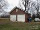A brick garage with two bays and white doors at 1040 Nc 90 W Hwy, Taylorsville, NC 20681