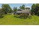 Beautiful two-story brick home with a lush green lawn and mature trees at 1040 Nc 90 W Hwy, Taylorsville, NC 20681