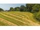 Image of vacant lot with partially cut grass, trees and houses in the background at 1040 Nc 90 W Hwy, Taylorsville, NC 20681