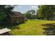 Brick outbuilding on a well-maintained lawn, suggesting ample space for outdoor activities and storage at 1040 Nc 90 W Hwy, Taylorsville, NC 20681