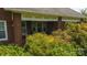 Welcoming brick porch entry with overhead shade, enhanced by lush landscaping for added privacy at 1040 Nc 90 W Hwy, Taylorsville, NC 20681