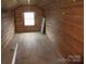 An unfinished room featuring wooden paneled walls and a bright window at 1040 Nc 90 W Hwy, Taylorsville, NC 20681