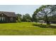 Well-manicured front yard with mature shade tree and classic swing provides a serene outdoor space at 1040 Nc 90 W Hwy, Taylorsville, NC 20681
