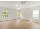 Spacious bedroom with light hardwood floors, a ceiling fan, and natural light from three windows at 1055 Doran Ter, Richburg, SC 29729