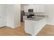 Modern kitchen with white cabinets, stainless steel appliances, and granite countertops, and hardwood floors at 1055 Doran Ter, Richburg, SC 29729