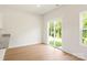 Living area with a sliding glass door that leads to a patio overlooking a green common area at 1055 Doran Ter, Richburg, SC 29729