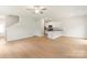 Bright and airy living room featuring hardwood floors, staircase, and a view into the kitchen at 1055 Doran Ter, Richburg, SC 29729