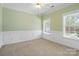Well-lit bedroom with decorative wall trim, two windows, and neutral carpet at 1141 Ardwyck Pl, Rock Hill, SC 29730
