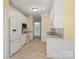Bright kitchen features white cabinetry, modern appliances, and neutral tile flooring at 1141 Ardwyck Pl, Rock Hill, SC 29730