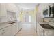 Bright kitchen with white cabinetry, white backsplash and stainless steel appliances at 1141 Ardwyck Pl, Rock Hill, SC 29730