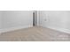 Bedroom with neutral carpet, white walls, and a doorway at 115 W 5Th Ave, Gastonia, NC 28052