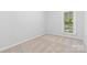 Bedroom with neutral carpet, white walls and trim, and a window at 115 W 5Th Ave, Gastonia, NC 28052