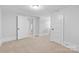 Bedroom with neutral carpet, white walls, and multiple doors at 115 W 5Th Ave, Gastonia, NC 28052