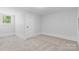Bedroom with neutral carpet, white walls and trim, and a window at 115 W 5Th Ave, Gastonia, NC 28052