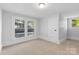 Bright bedroom with neutral carpet, white trim, and natural light from two windows at 115 W 5Th Ave, Gastonia, NC 28052