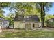 Back exterior view of home with covered porch and well maintained yard with mature trees at 115 W 5Th Ave, Gastonia, NC 28052