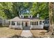 Charming one-story home with dormer windows and a welcoming front porch surrounded by mature trees and ample space at 115 W 5Th Ave, Gastonia, NC 28052