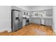 Kitchen features stainless steel appliances, granite countertops, and wood-look flooring with ample cabinet space at 115 W 5Th Ave, Gastonia, NC 28052