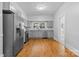 Efficient kitchen layout with stainless steel appliances, wood-look flooring, and light gray cabinetry at 115 W 5Th Ave, Gastonia, NC 28052