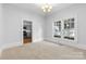 A bright, neutrally decorated room featuring carpet flooring and natural light at 115 W 5Th Ave, Gastonia, NC 28052