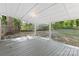 Covered outdoor patio space perfect for entertaining, featuring a wood deck floor and white ceiling at 115 W 5Th Ave, Gastonia, NC 28052