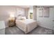 Comfortable bedroom with a lamp-lit side table and a soft, inviting comforter at 135 Meadow View Dr, Statesville, NC 28677