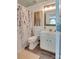 Updated bathroom featuring a white vanity, framed mirror, shower with patterned curtain, and wood-look flooring at 136 Elba Dr, Mooresville, NC 28115