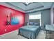 Stylish bedroom with a bright accent wall, guitar decor, tray ceiling, and natural light at 136 Elba Dr, Mooresville, NC 28115