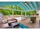 Relaxing covered deck featuring comfortable outdoor seating, a bar, a view of the backyard, and a swimming pool at 136 Elba Dr, Mooresville, NC 28115