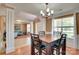 Open-concept dining room with hardwood floors, chandelier lighting, and seamless access to the living spaces at 136 Elba Dr, Mooresville, NC 28115