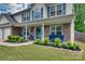 Inviting front porch with stone accents, comfortable seating, and manicured shrubs for relaxing outdoors at 136 Elba Dr, Mooresville, NC 28115