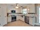 Modern kitchen featuring stainless steel appliances, white cabinets, and tile backsplash at 136 Elba Dr, Mooresville, NC 28115