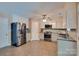 Modern kitchen with stainless steel appliances, white cabinets, and tile backsplash for culinary enthusiasts at 136 Elba Dr, Mooresville, NC 28115