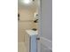 Bright laundry room featuring a washing machine, shelf with laundry detergent, and hanging rack for convenience at 136 Elba Dr, Mooresville, NC 28115